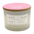 California Citron candle with pink lid and 'Sand + Paws' label on a white background