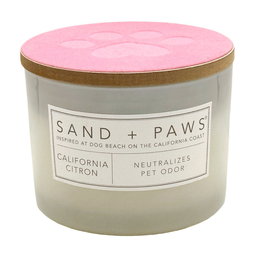 California Citron candle with pink lid and 'Sand + Paws' label on a white background