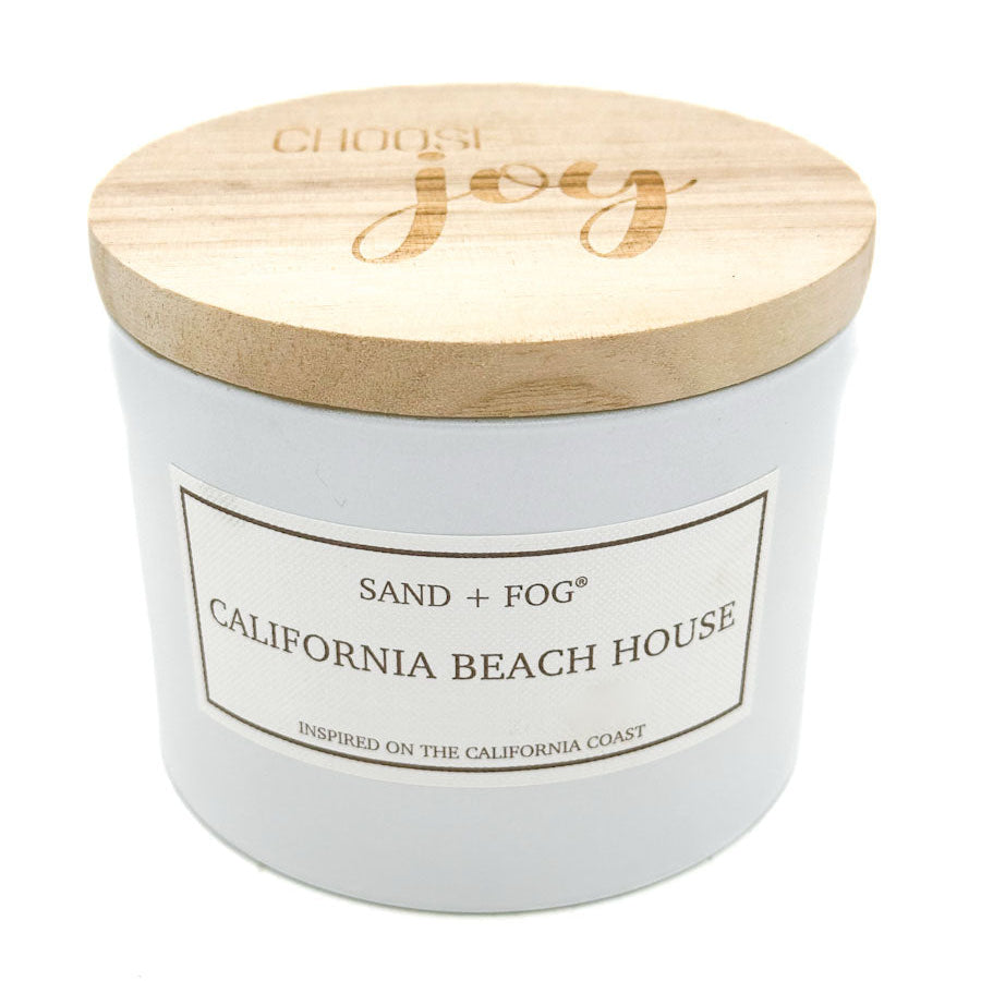 SAND + FOG White candle with wooden lid labeled 'California Beach House' on a white background