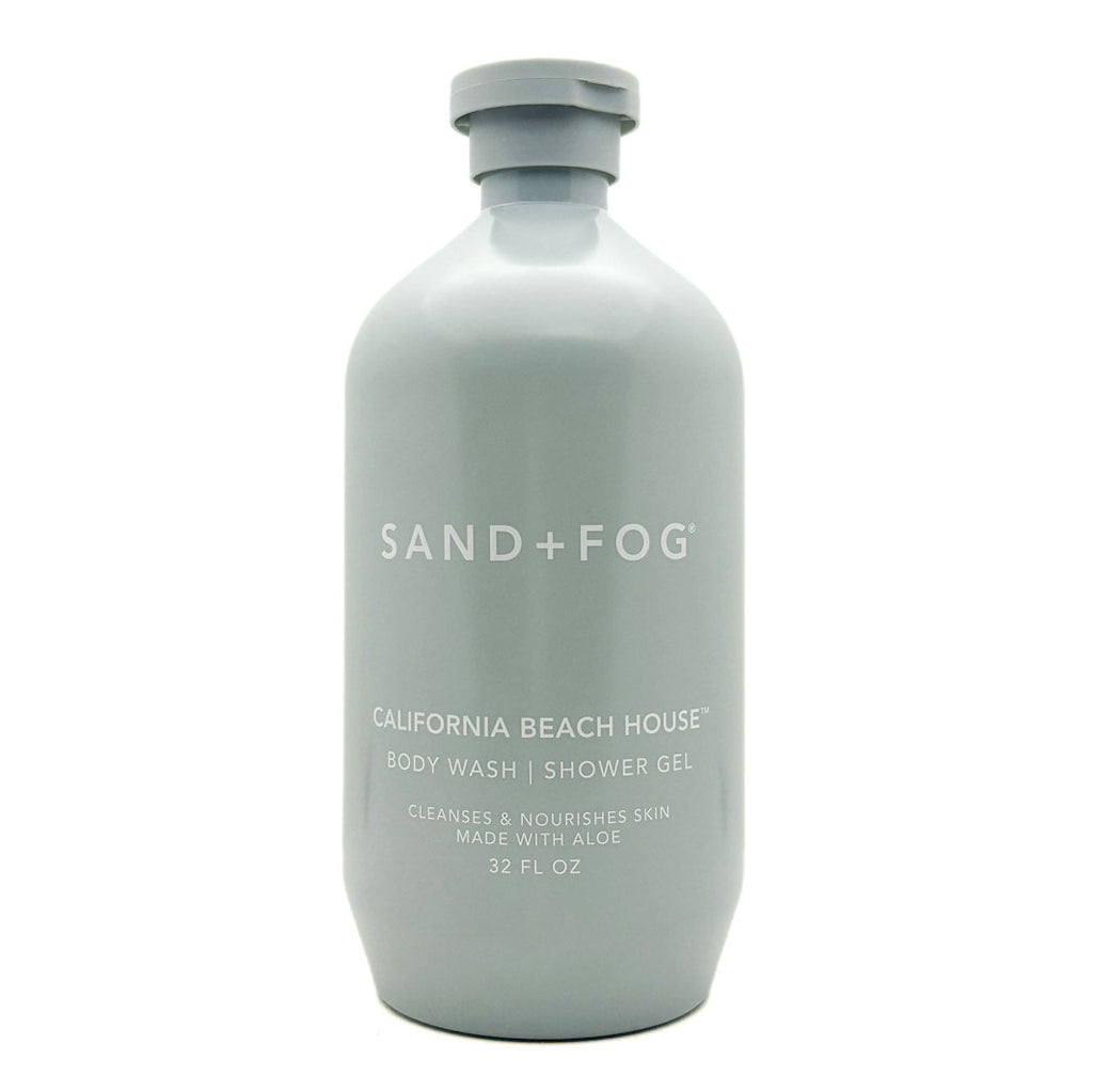 A 32 fl oz matte light gray bottle of Sand + Fog California Beach House body wash shower gel on a white background.