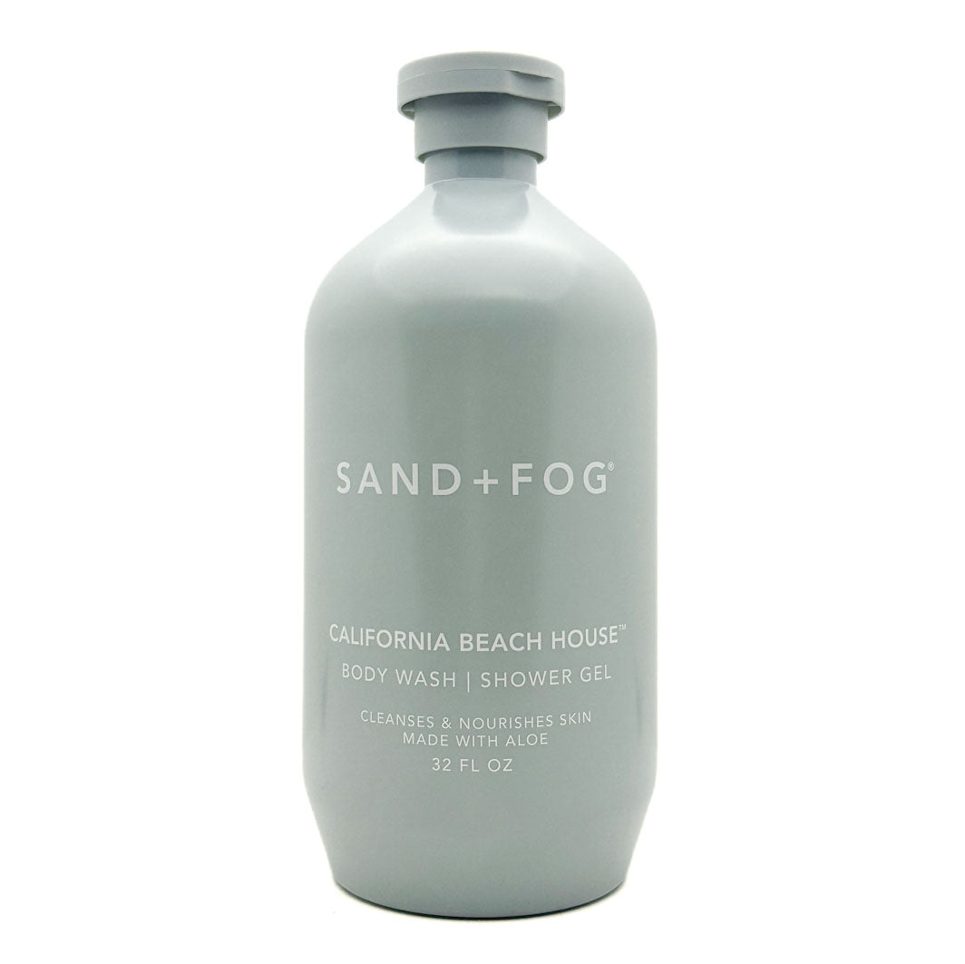 A 32 fl oz matte light gray bottle of Sand + Fog California Beach House body wash shower gel on a white background.