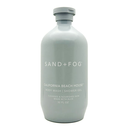 A 32 fl oz matte light gray bottle of Sand + Fog California Beach House body wash shower gel on a white background.