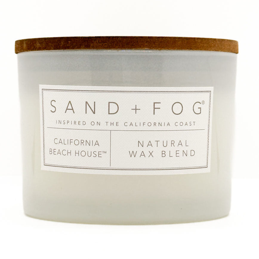 California Beach House candle with 'Sand + Fog' label on a white background