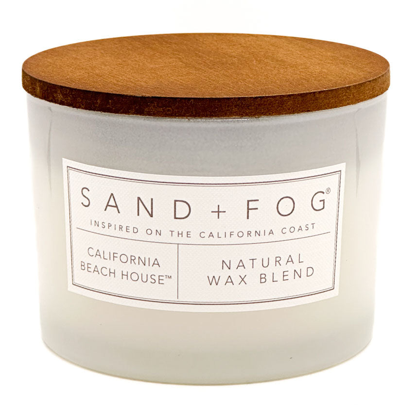 California Beach House candle with a wooden lid labeled 'Sand + Fog' on a white background