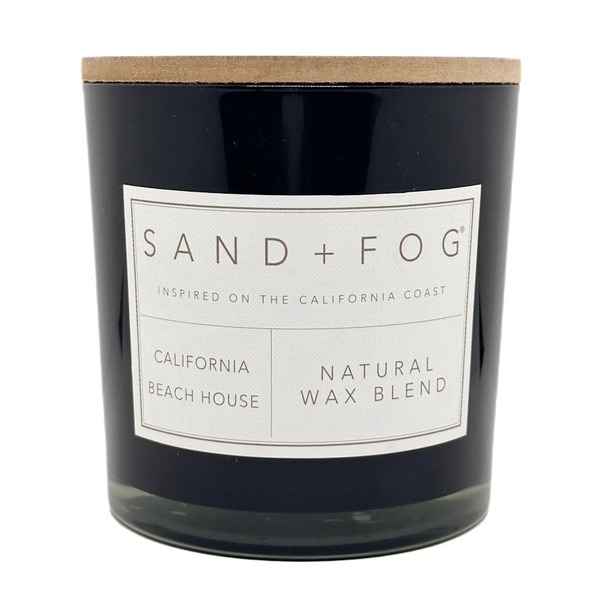 California Beach House Candle with a label reading 'Sand + Fog' on a white background