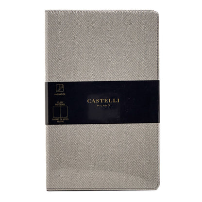 A single Castelli Milano planner cover in a light grey herringbone fabric, wrapped with a black paper band featuring the brand name in gold.