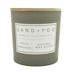 Citrus & Sandalwood scented candle with 'Sand + Fog' label on a white background