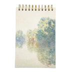 Sketchbook with a spiral binding featuring a watercolour design of trees and a path on the cover.