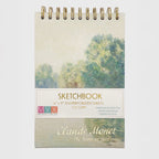 Sketchbook with a cover featuring a painting of trees by Claude Monet on a white background