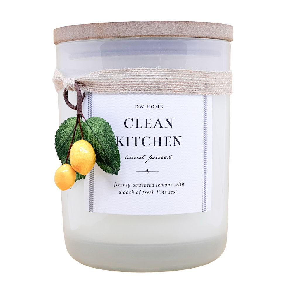 DW Home candle labeled 'Clean Kitchen' with lemon and leaf decorations on a white background