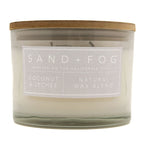 SAND + FOG Coconut & Lychee candle with a wooden lid and label on a white background