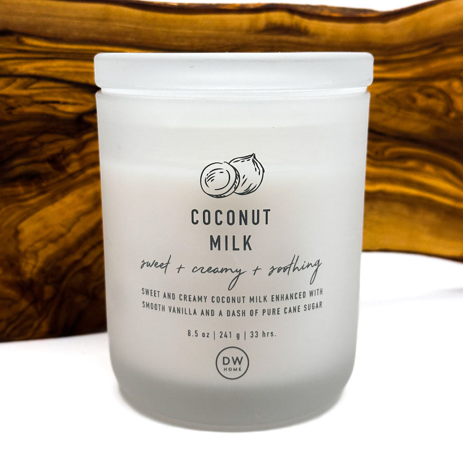 Frosted jar of coconut milk with DW Home logo on a wooden surface