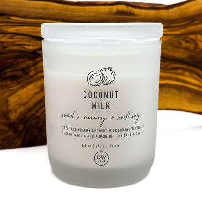 Frosted jar of coconut milk with DW Home logo on a wooden surface