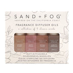 Sand + Fog fragrance diffuser oils with four bottles on a decorative background.