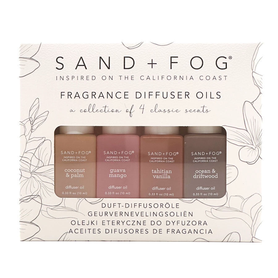 Sand + Fog fragrance diffuser oils with four bottles on a decorative background.