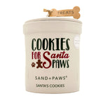 Dog treat candle jar labeled 'Cookies for Santa Paws' by Sand + Paws on a white background