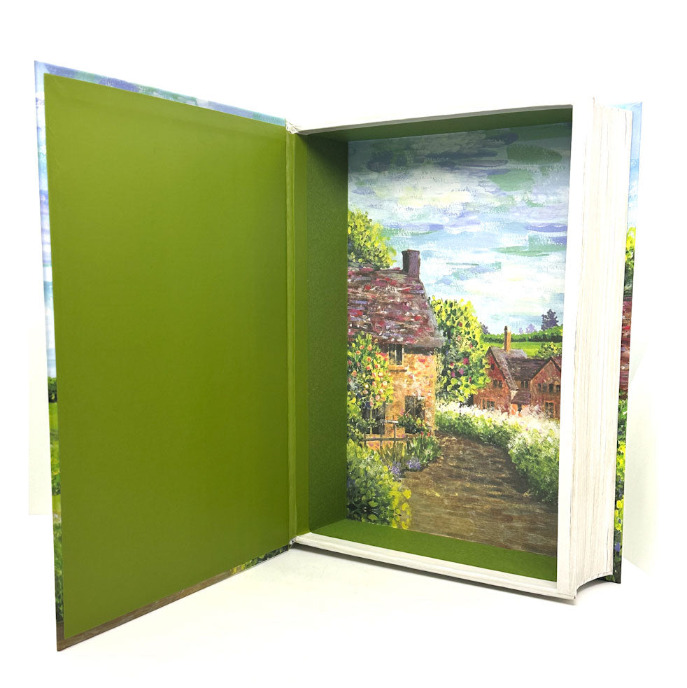 Open keepsake with a green cover and a painted landscape of a house and garden on the other page.