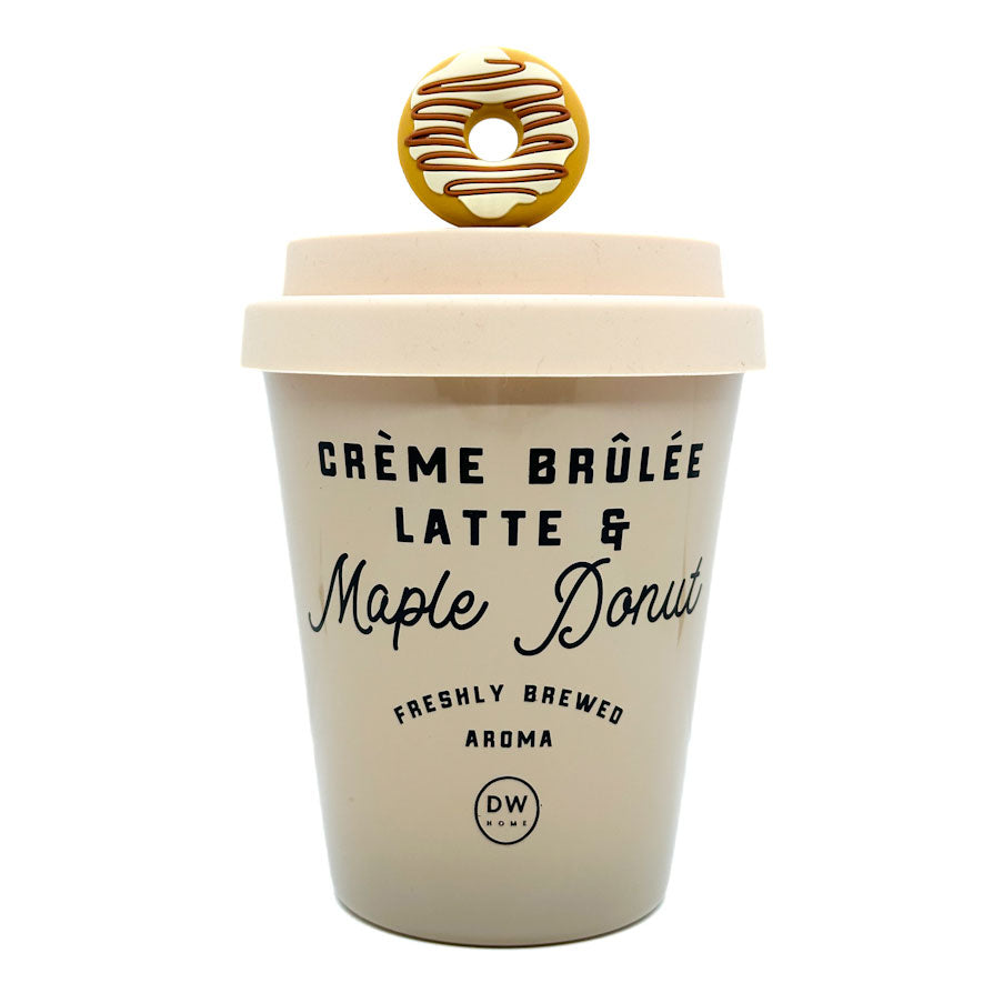 A scented candle designed to look like a cup of creme brulee latte and maple donut with a decorative donut on top.