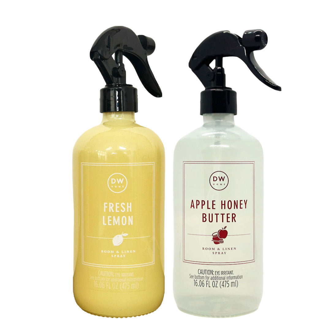 Two DW Home spray bottles, one yellow and one white, on a white background.