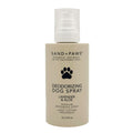 Deodorizing dog spray bottle with 'Sand + Paws' branding on a white background