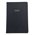A black woven-texture notebook with a small gold-embossed label reading 'NOTES' on the front, shown against a plain white background.