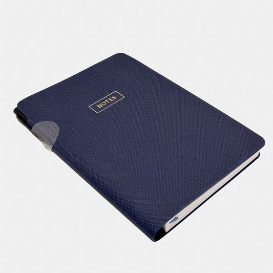 Eccolo navy blue textured notebook with a small gold 'NOTES' label on the cover, shown at an angle on a light grey background.