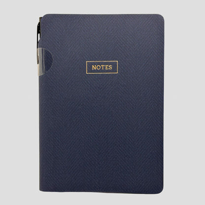 A navy blue textured hardcover notebook with a gold foil 'NOTES' label on the front, shown against a light gray background.