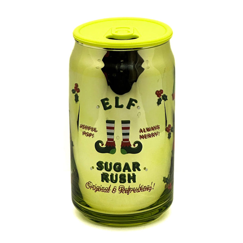DW Home Green Sugar Rush can-shaped candle with yellow lid featuring an elf design and text on a white background