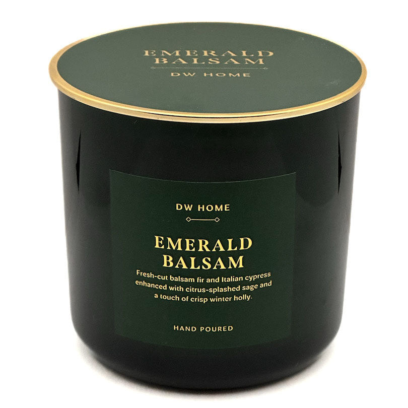 A dark green glass jar candle with a matching lid and a gold rim, featuring a dark green label with gold text that reads 'EMERALD BALSAM' and 'DW HOME'.