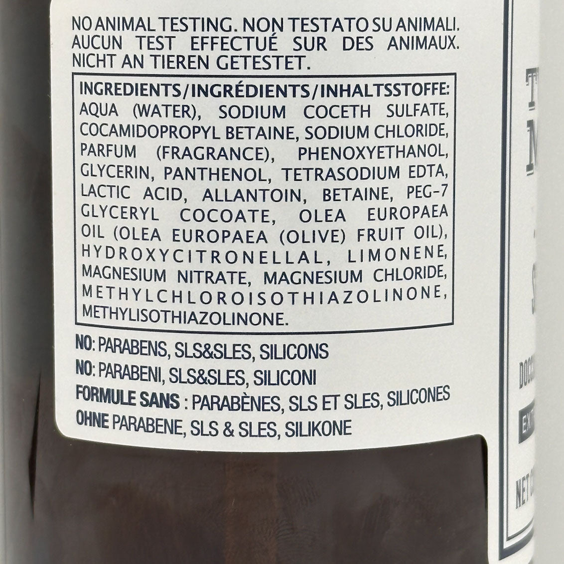 Product label with ingredient list and safety information on a bottle.