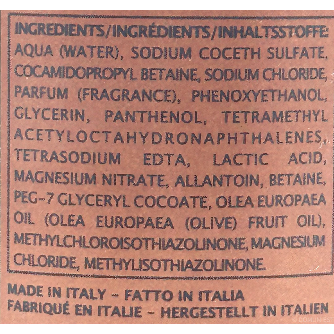 Close-up of a brown product label with black printed text listing ingredients in Italian and stating 'Made in Italy' at the bottom.