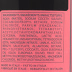 Close-up of a red product label showing the ingredients list in dark purple text, including aqua water, sodium cocoth sulfate, betaine, fragrance, and other additives, with 'Made in Italy' at the bottom.