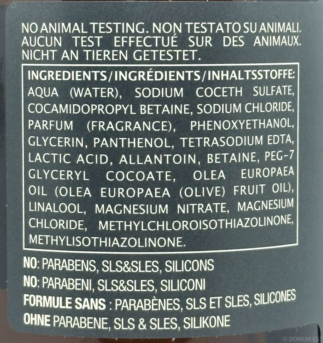 Product label with ingredient list and safety claims on a dark background