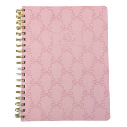 FRINGE Pink notebook with bow pattern and 'Notes' label on a white background