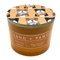 Falling Leaves Candle with dog-themed lid and 'Sand + Paws' label on a white background