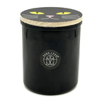 Falling Leaves Black candle jar with cat face design on lid and 'Sand + Fog' logo.