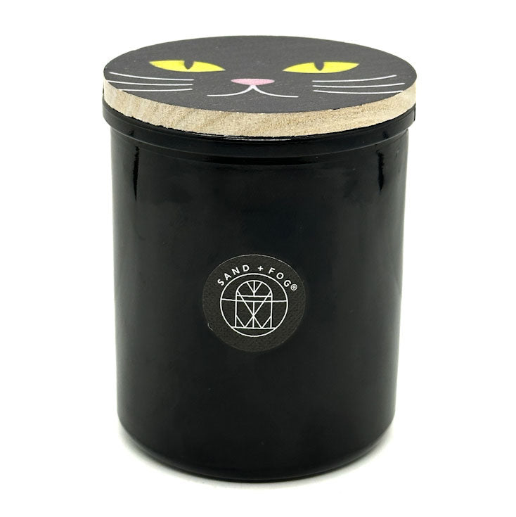 Falling Leaves Black candle jar with cat face design on lid and 'Sand + Fog' logo.