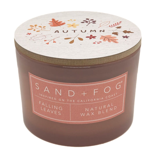Falling Leaves peach candle with 'Sand + Fog' label and leaf pattern on lid against a white background