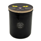 SAND + FOG Falling Leaves black votive candle with a cat face design on the lid on a white background