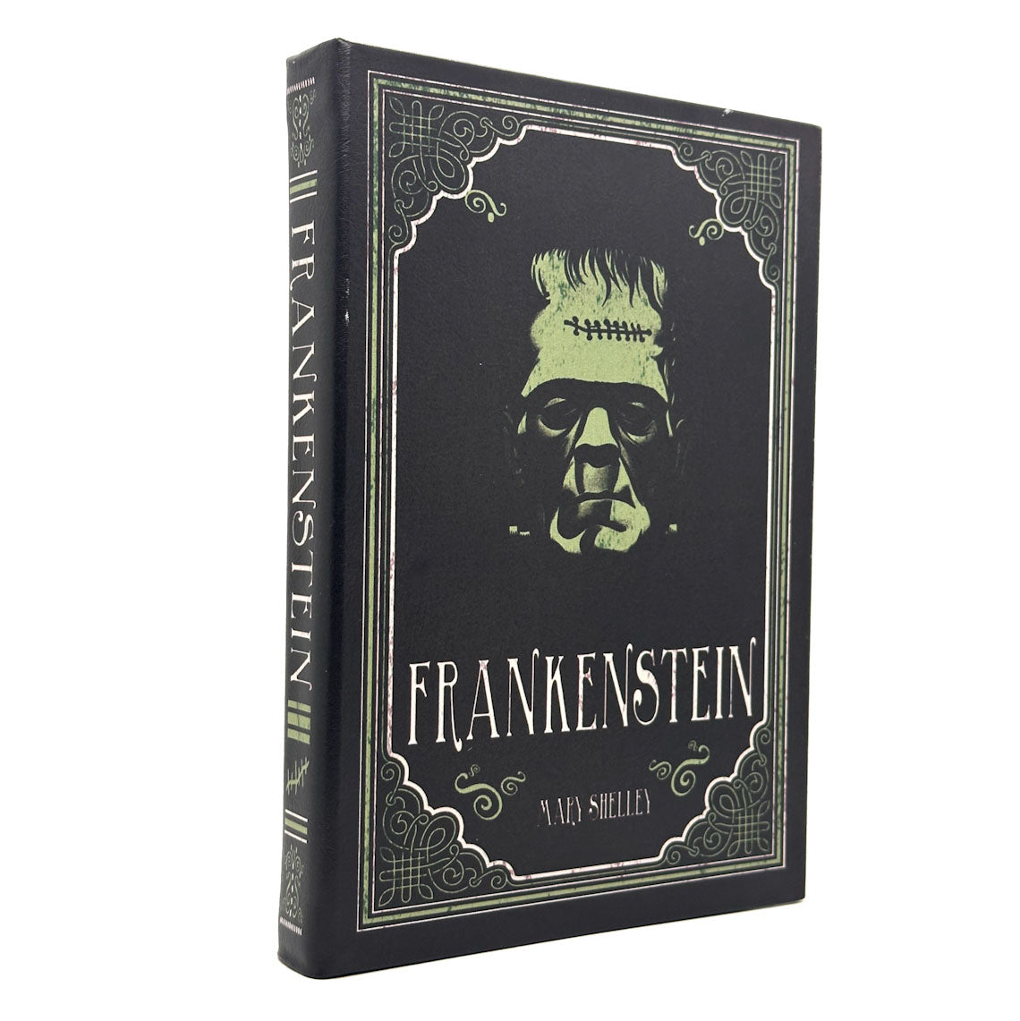 A hardcover Notebook of Frankenstein by Mary Shelley, featuring a black cover with a pale green illustration of the creature's face and ornate vintage-style borders, shown standing upright on a white background.