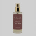 Linen spray bottle labeled 'French Lavender' by Sand + Fog on a grey background
