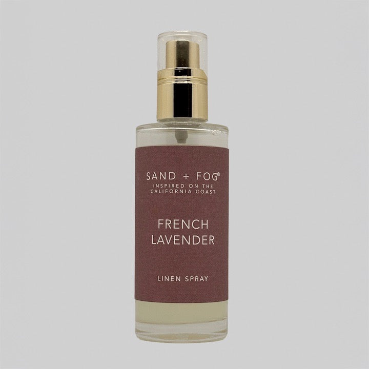 Linen spray bottle labeled 'French Lavender' by Sand + Fog on a grey background