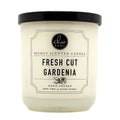 Candle with a label indicating 'Fresh Cut Gardenia' fragrance on a white background