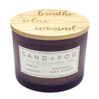 Purple candle with a wooden lid featuring motivational phrases on a white background