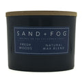 Fresh Woods blue candle with a label reading 'Sand + Fog' on a white background