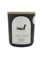 Candle with 'Sand + Paws' branding and 'Fright Night' scent on a white background