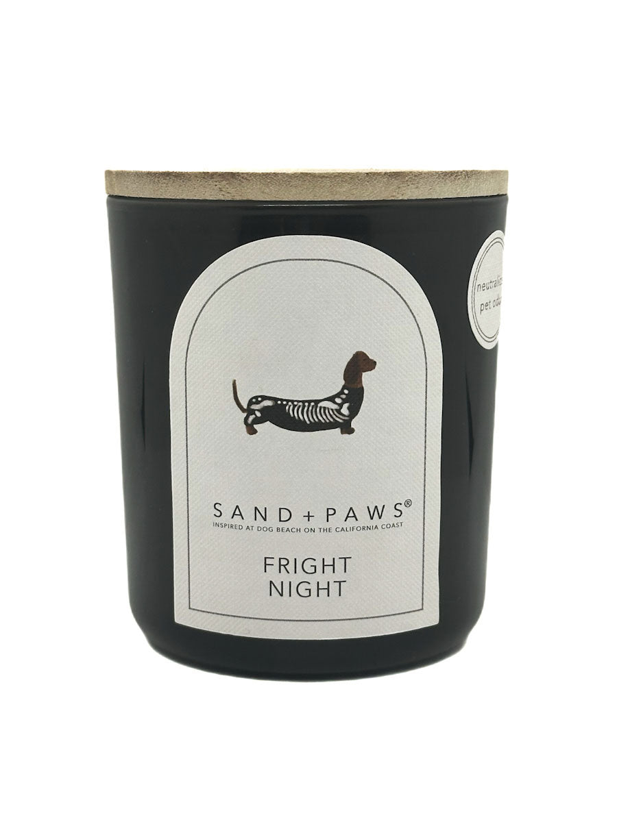 Candle with 'Sand + Paws' branding and 'Fright Night' scent on a white background
