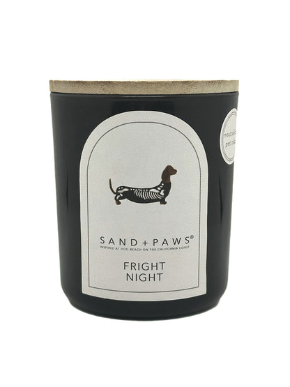 Candle with 'Sand + Paws' branding and 'Fright Night' scent on a white background
