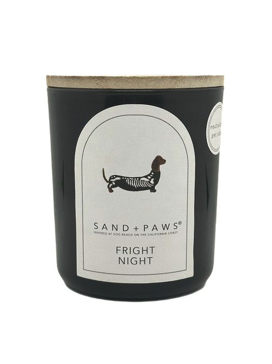 Candle with 'Sand + Paws' branding and 'Fright Night' scent on a white background