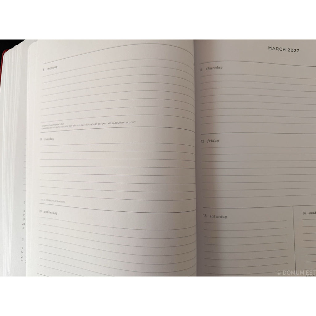 An open planner or notebook showing lined weekly and daily pages for March 2027, photographed against a white background.